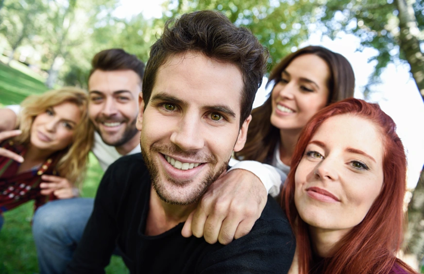 young people in group smiling to camera